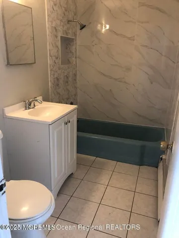 a bathroom with a sink a toilet and mirror