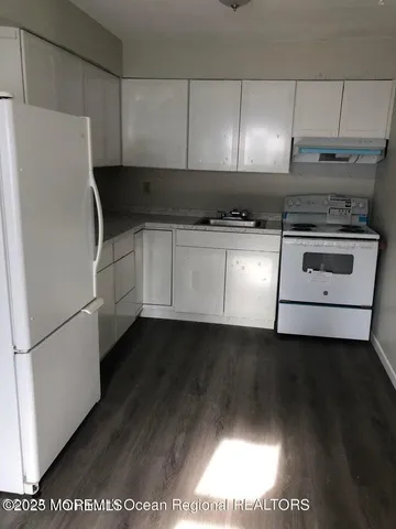 a kitchen with a refrigerator and a stove