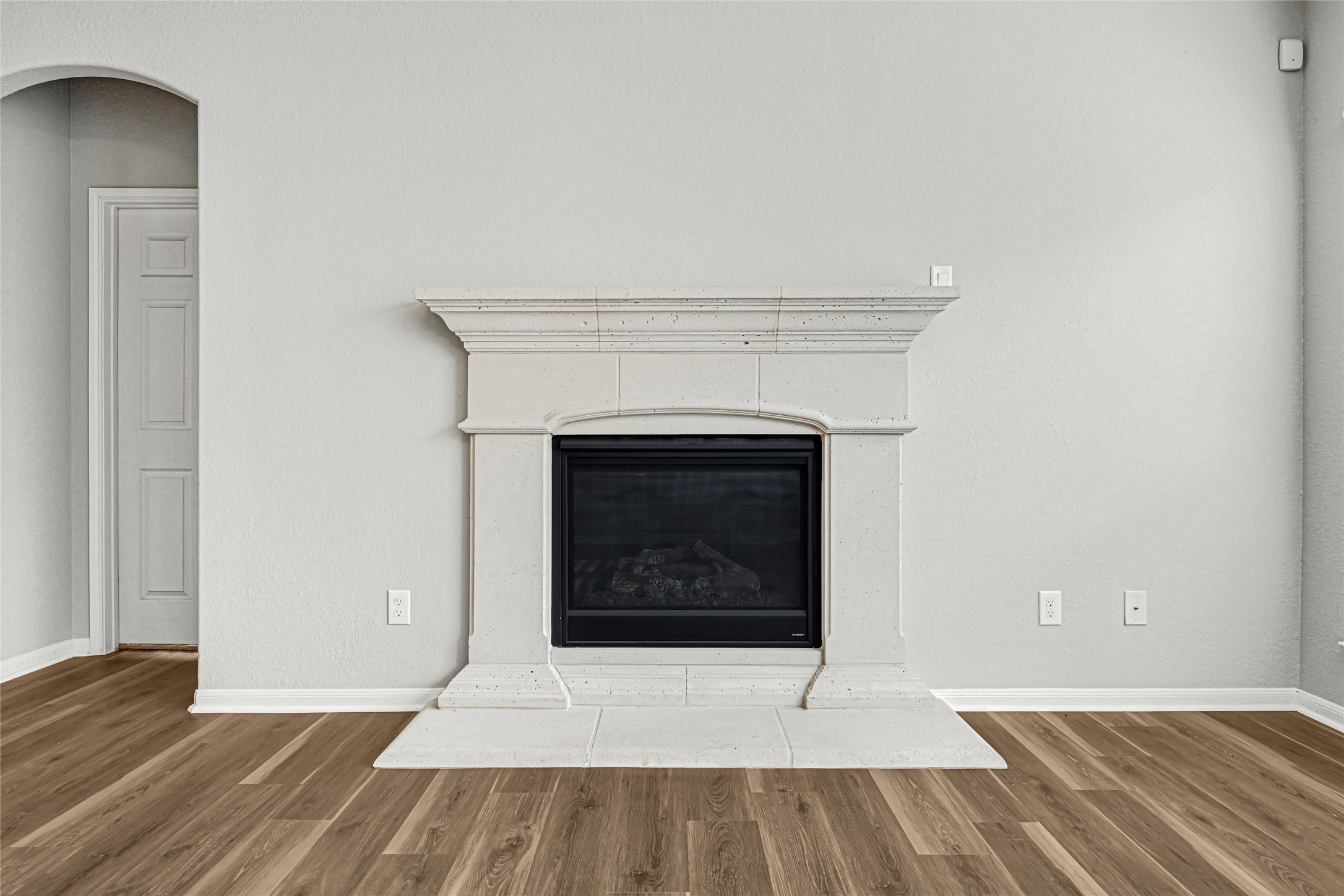 5331 Seabird Street Baytown, TX 77521 - Photo 15 of 38 a view of an empty room with wooden floor and a fireplace