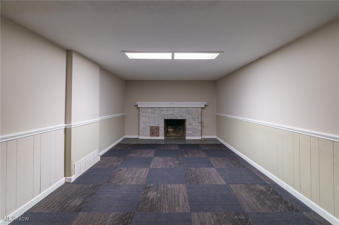 3165 East Sprague Road Independence, OH 44131 - Photo 28 of 41 large room in basement that was used as master bedroom, it has a second fireplace with lovely stone front and mantel