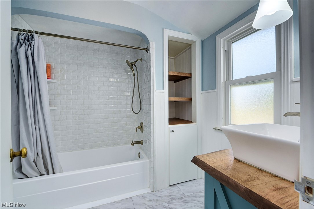 19646 Henry Road Fairview Park, OH 44126 - Photo 19 of 35 Bathroom featuring light flooring, shower / bath combo.