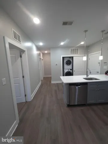 a large room with a lot of counter space and wooden floor