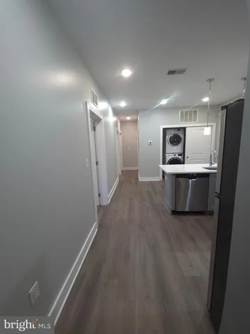 a view of a hallway with a kitchen