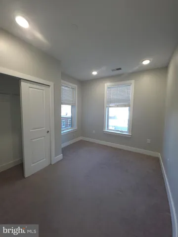an empty room with a empty space and windows