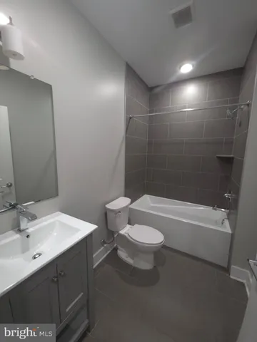a bathroom with a sink a toilet and bathtub