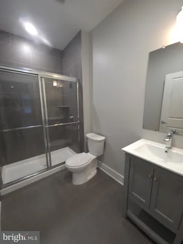a bathroom with a toilet sink and shower
