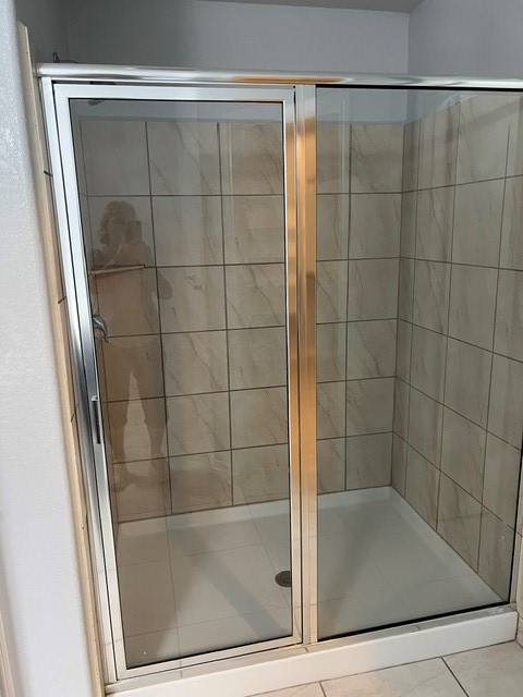 18303 Ranch View Trail Houston, TX 77073 - Photo 11 of 19 Modern glass-enclosed shower with elegant tile design, offering a sleek and functional bathroom space.