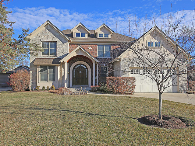 527 Ranch Road Wheaton, IL 60187 - Photo 1 of 25 a front view of a house with a yard