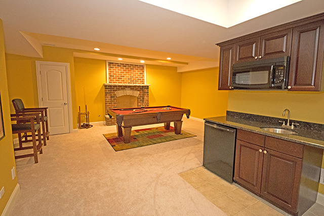 527 Ranch Road Wheaton, IL 60187 - Photo 17 of 25 a living room with stainless steel appliances kitchen island granite countertop furniture and a refrigerator