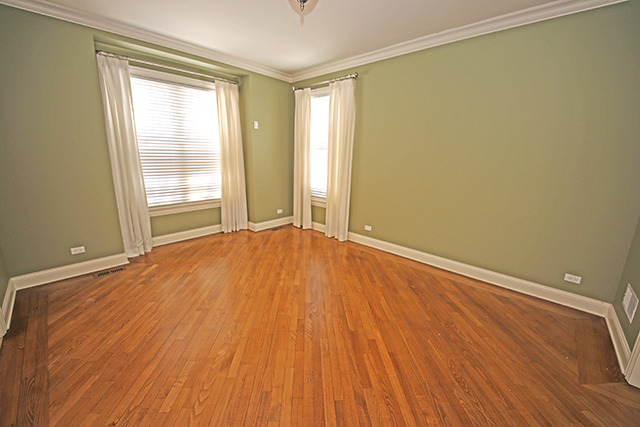 527 Ranch Road Wheaton, IL 60187 - Photo 4 of 25 an empty room with wooden floor and windows