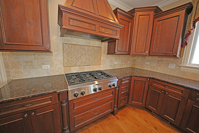 527 Ranch Road Wheaton, IL 60187 - Photo 7 of 25 a kitchen with granite countertop wooden cabinets and white appliances