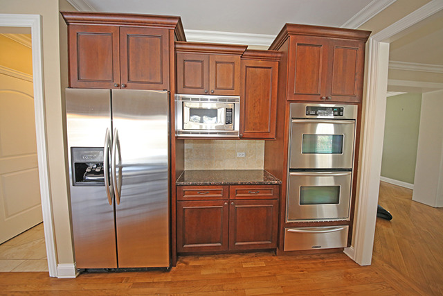 527 Ranch Road Wheaton, IL 60187 - Photo 8 of 25 a kitchen with stainless steel appliances granite countertop a refrigerator and a stove top oven