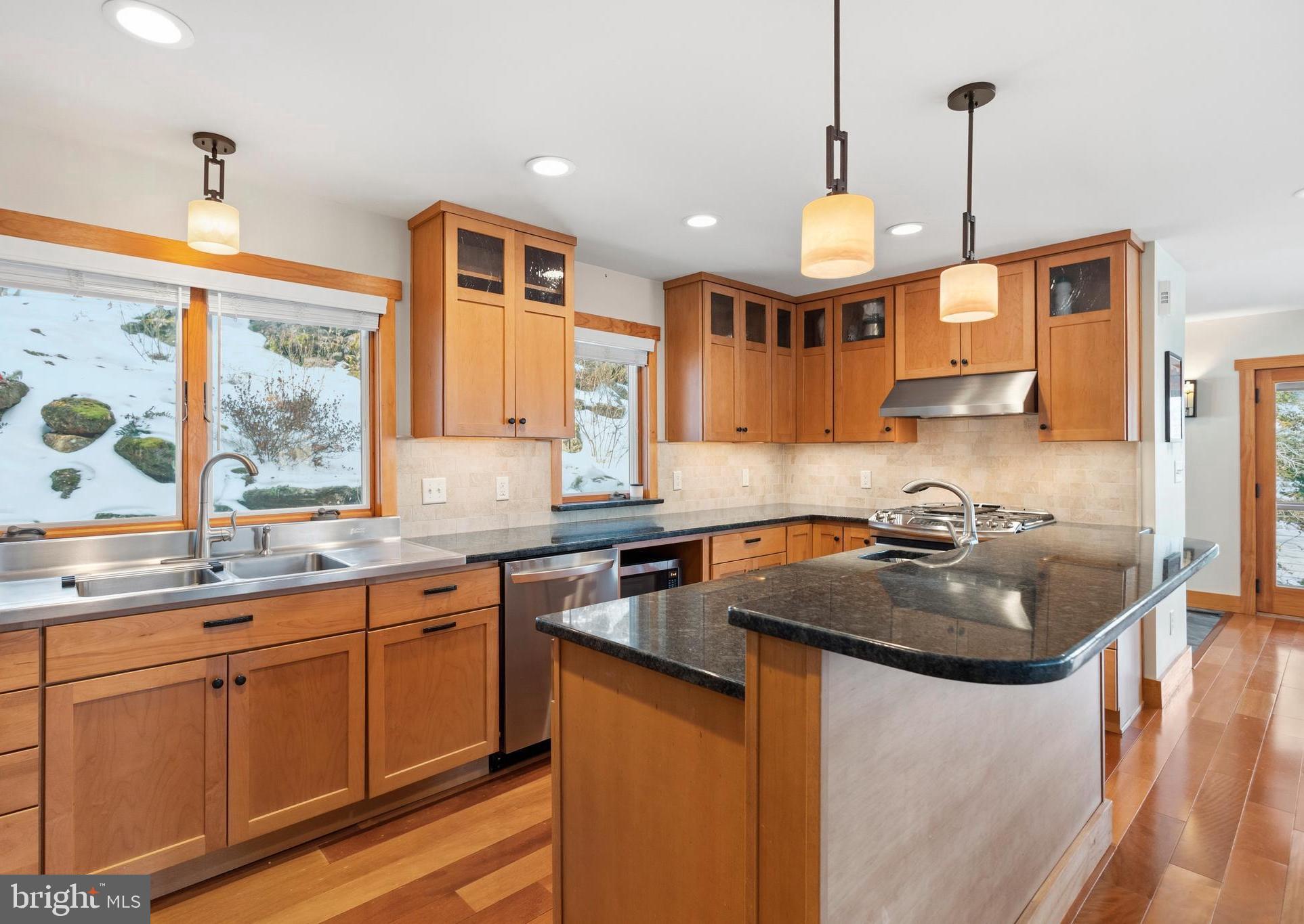357 Overlook Trail Annapolis, MD 21401 - Photo 15 of 45 a kitchen with a sink a center island a stove and a window