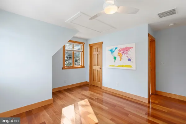 a view of room with wooden floor and fan
