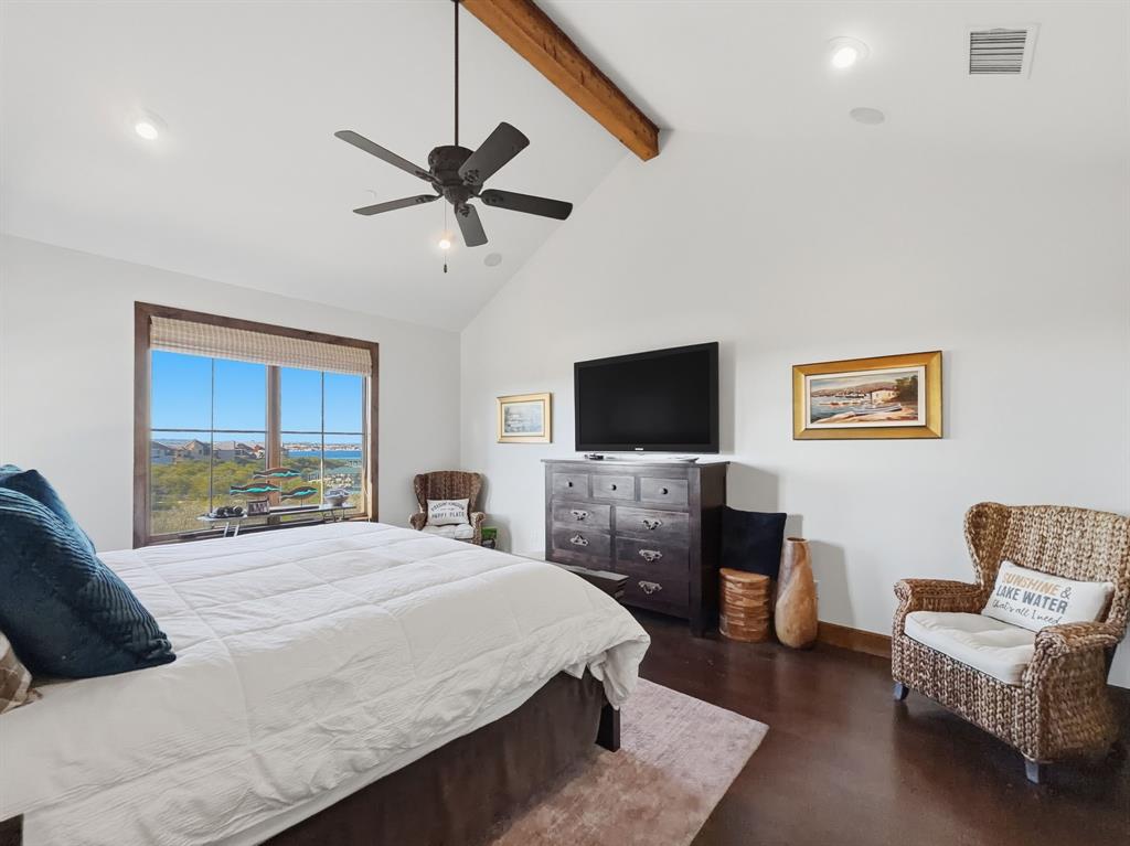 2033 Harbor Way, Unit 302 Graford, TX 76449 - Photo 15 of 28 a bedroom with a bed and a flat screen tv