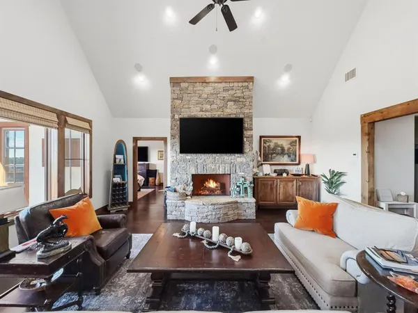 a living room with furniture a fireplace and a flat screen tv