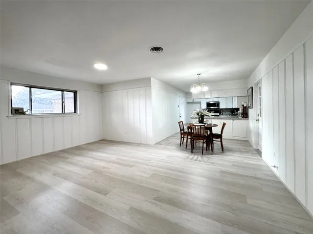 a view of a livingroom with furniture wooden floor and a window