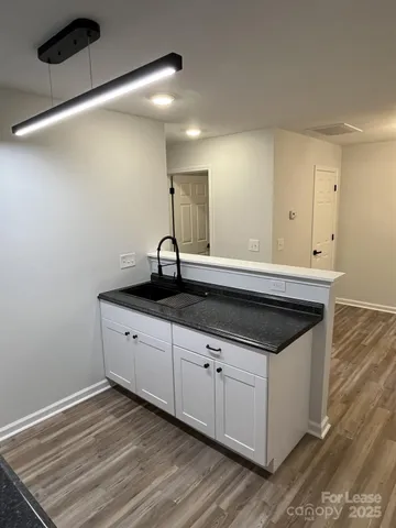 a kitchen with a sink and cabinets