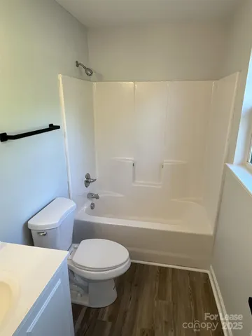 a bathroom with a toilet and a bath tub