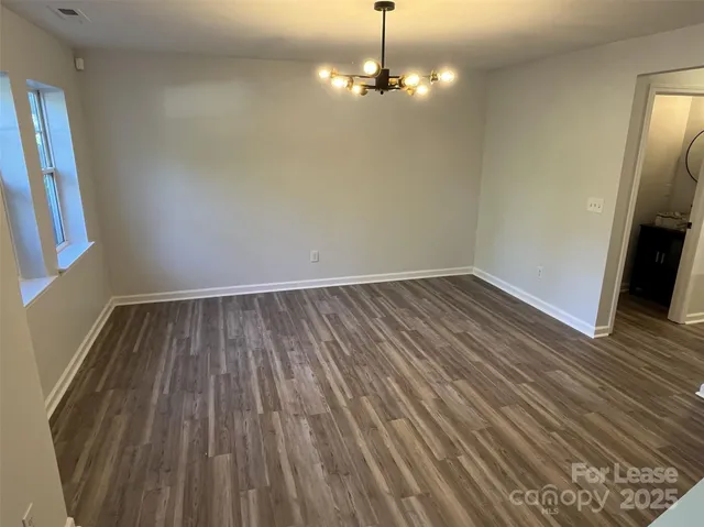 wooden floor in an empty room with a mirror
