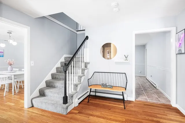 a view of entryway and hall with wooden floor