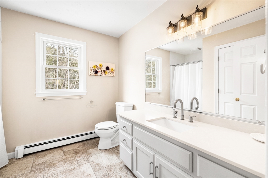 13 Jonathans Way Upton, MA 01568 - Photo 20 of 36 a bathroom with a sink and a mirror