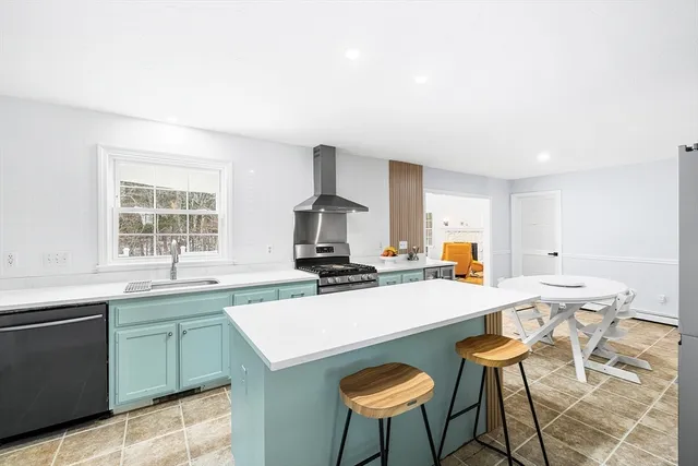 a kitchen with a stove a sink and a refrigerator