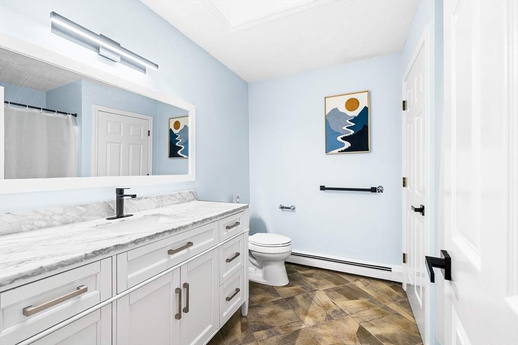 13 Jonathans Way Upton, MA 01568 - Photo 27 of 36 a bathroom with a granite countertop sink and a mirror