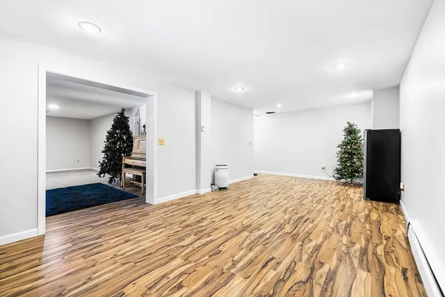 a bedroom with a bed and a wooden floor