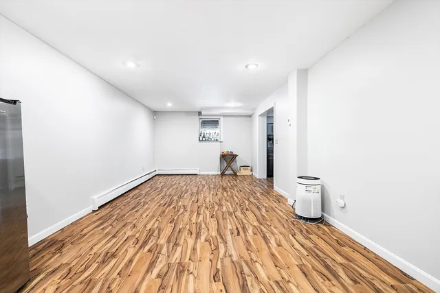 a spacious bedroom with a bed and a window