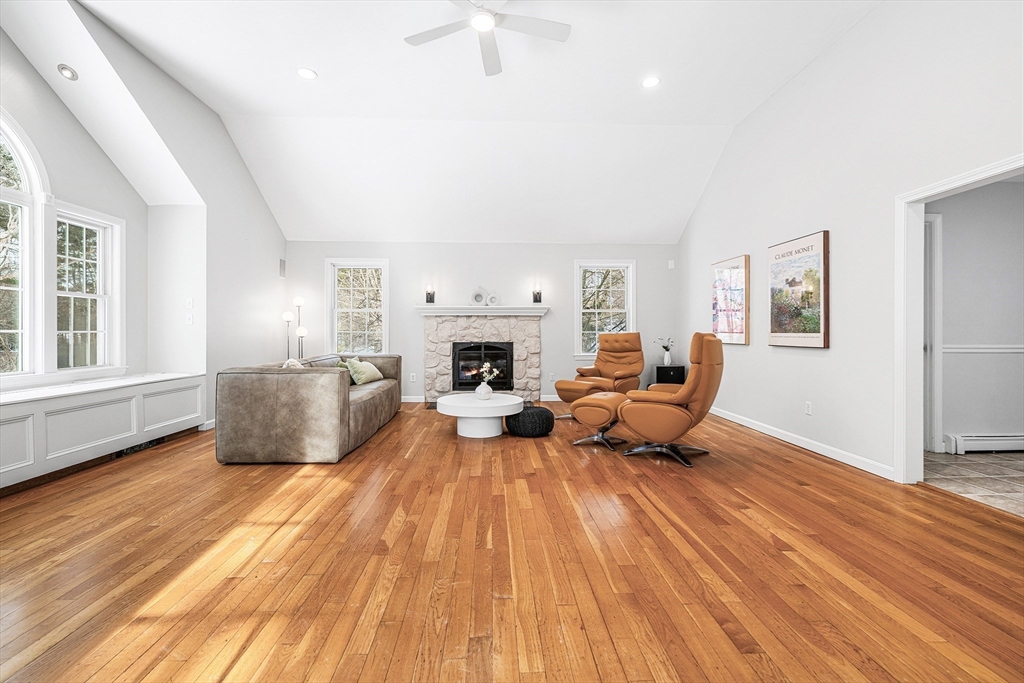 13 Jonathans Way Upton, MA 01568 - Photo 6 of 36 a living room with furniture wooden floor and a fireplace
