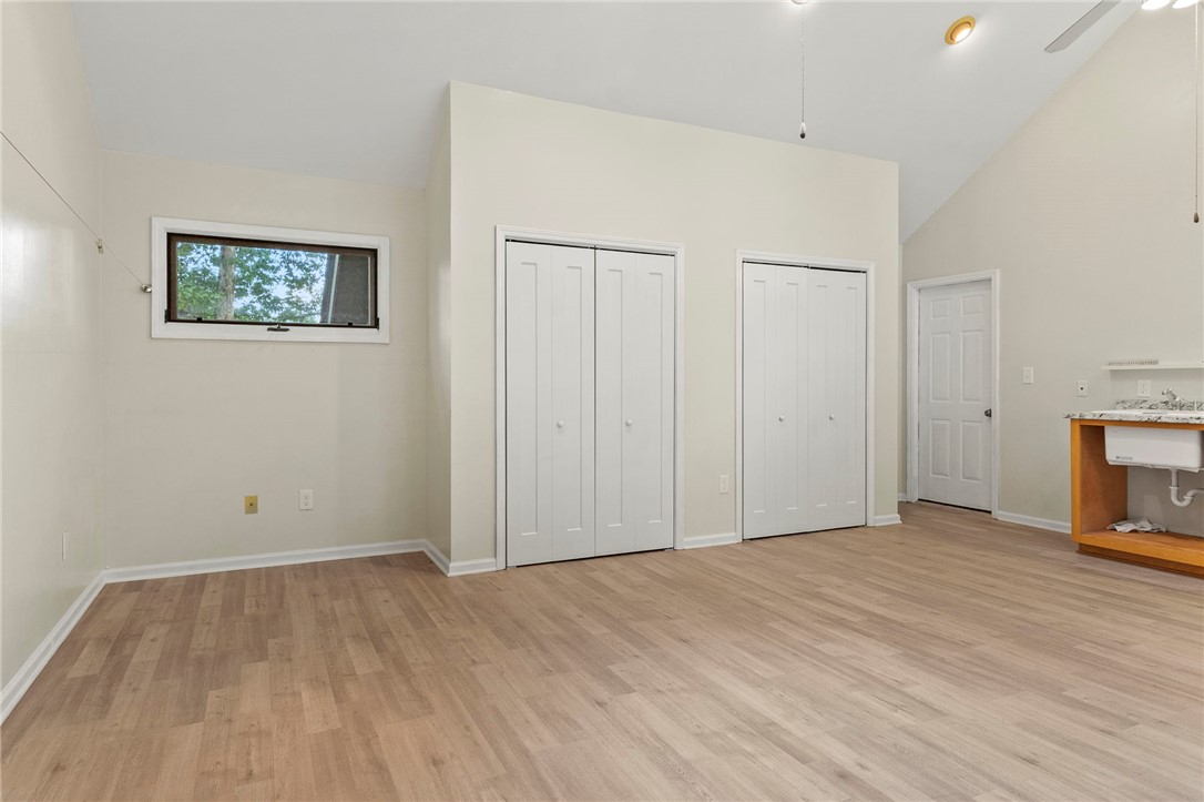 225 Arrowhead Trail Easley, SC 29642 - Photo 23 of 33 This versatile room features warm flooring and vaulted ceilings, perfect for a dynamic living space.