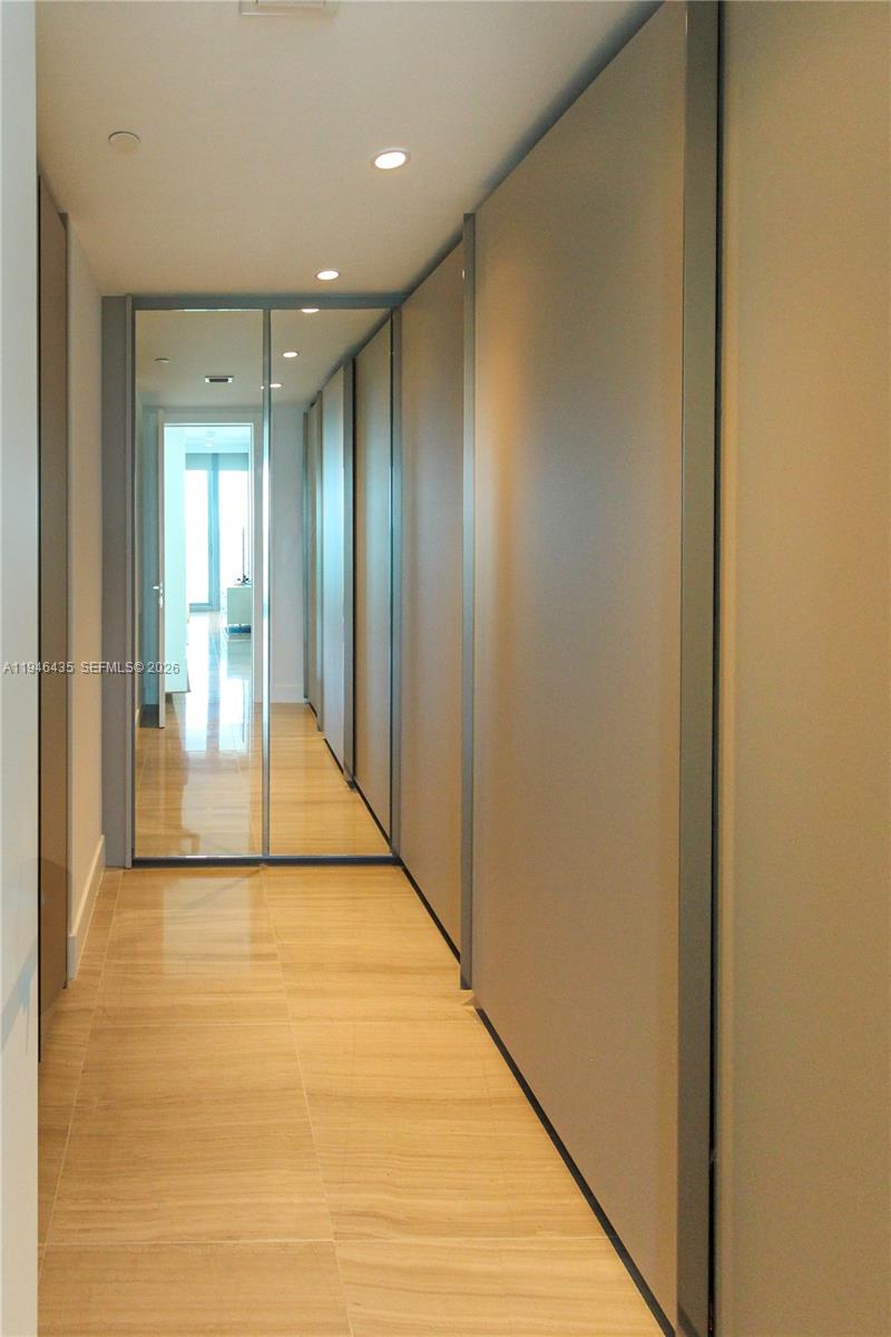 6901 Collins Avenue, Unit 901 Miami Beach, FL 33141 - Photo 11 of 21 a view of a hallway with wooden floor