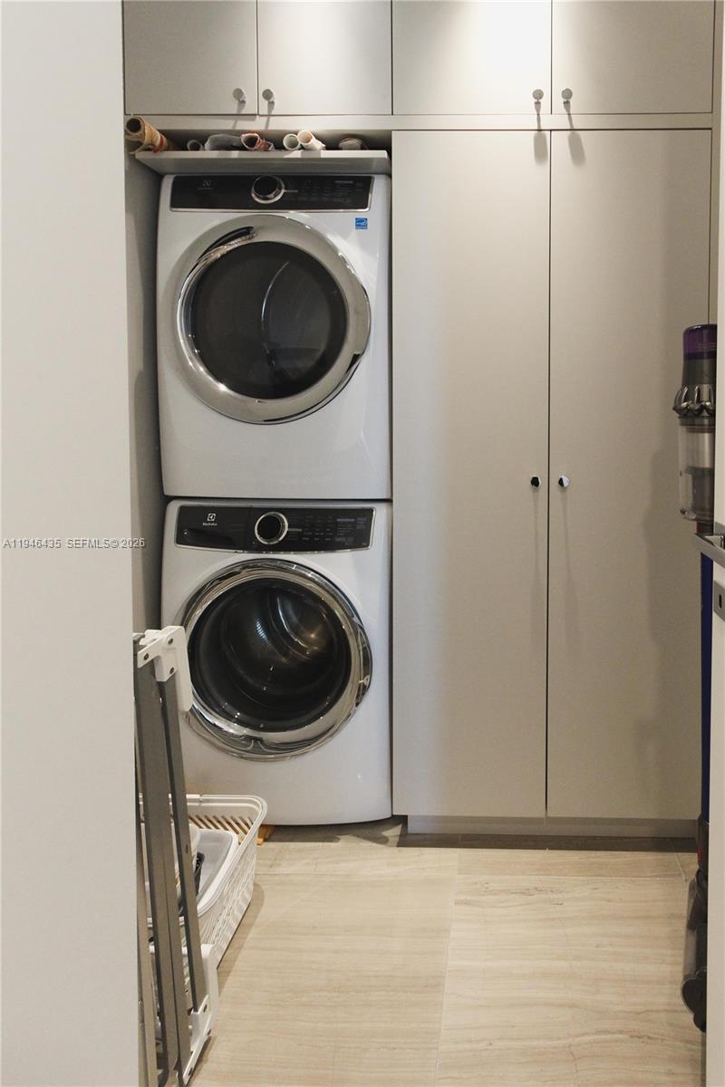 6901 Collins Avenue, Unit 901 Miami Beach, FL 33141 - Photo 16 of 21 a utility room with dryer and washer