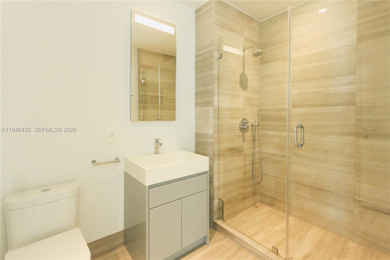 6901 Collins Avenue, Unit 901 Miami Beach, FL 33141 - Photo 18 of 21 a bathroom with a sink a toilet and shower