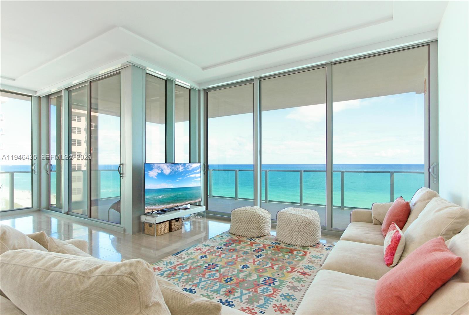 6901 Collins Avenue, Unit 901 Miami Beach, FL 33141 - Photo 5 of 21 a living room with large windows