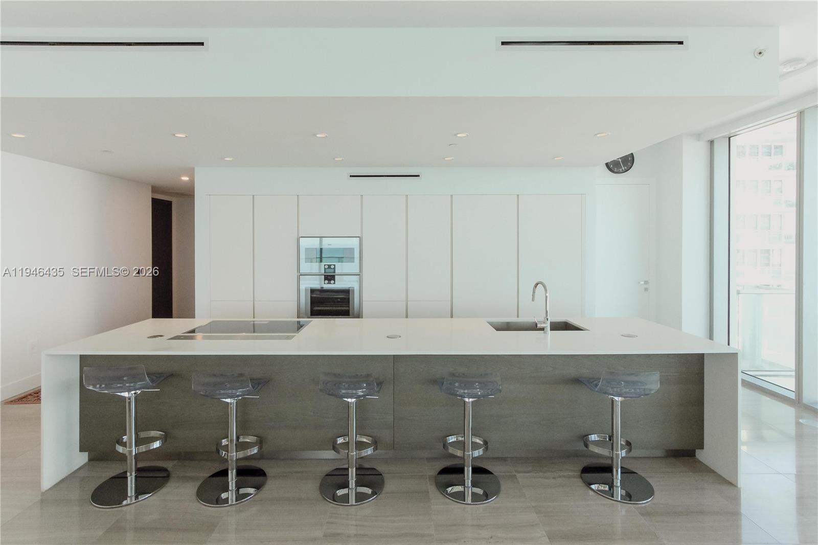 6901 Collins Avenue, Unit 901 Miami Beach, FL 33141 - Photo 7 of 21 view of a kitchen with kitchen island a sink stainless steel appliances and cabinets