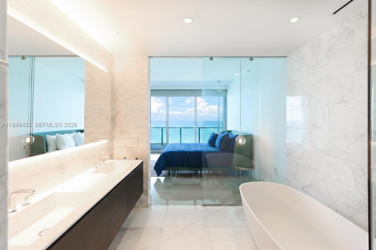 6901 Collins Avenue, Unit 901 Miami Beach, FL 33141 - Photo 9 of 21 a living room with furniture and a large window