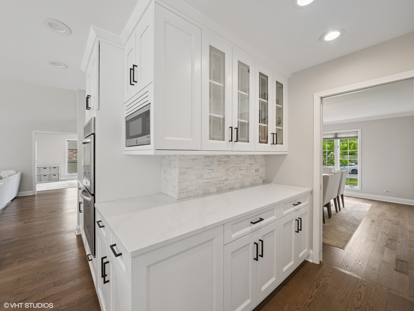1002 Elmdale Road Glenview, IL 60025 - Photo 12 of 51 a kitchen with cabinets and wooden floor