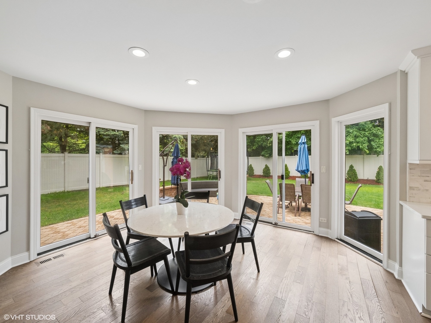 1002 Elmdale Road Glenview, IL 60025 - Photo 15 of 51 a dining room with furniture and a floor to ceiling window