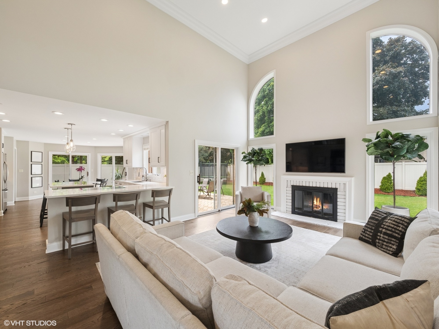1002 Elmdale Road Glenview, IL 60025 - Photo 18 of 51 a living room with furniture a fireplace and a large window