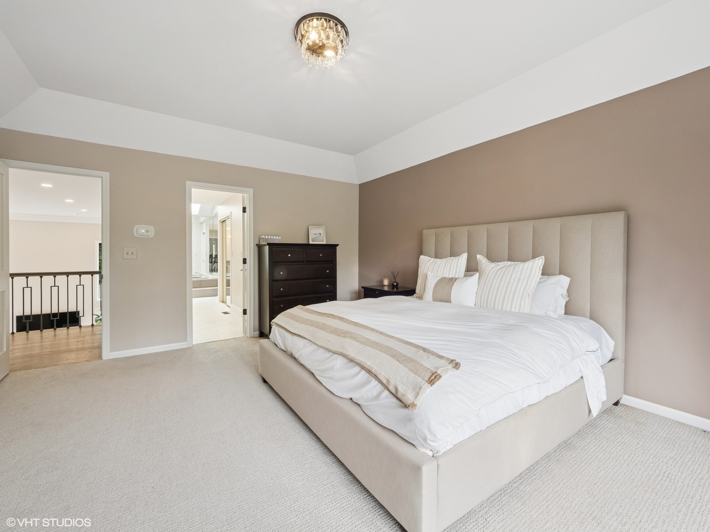 1002 Elmdale Road Glenview, IL 60025 - Photo 26 of 51 a spacious bedroom with a bed and a chandelier