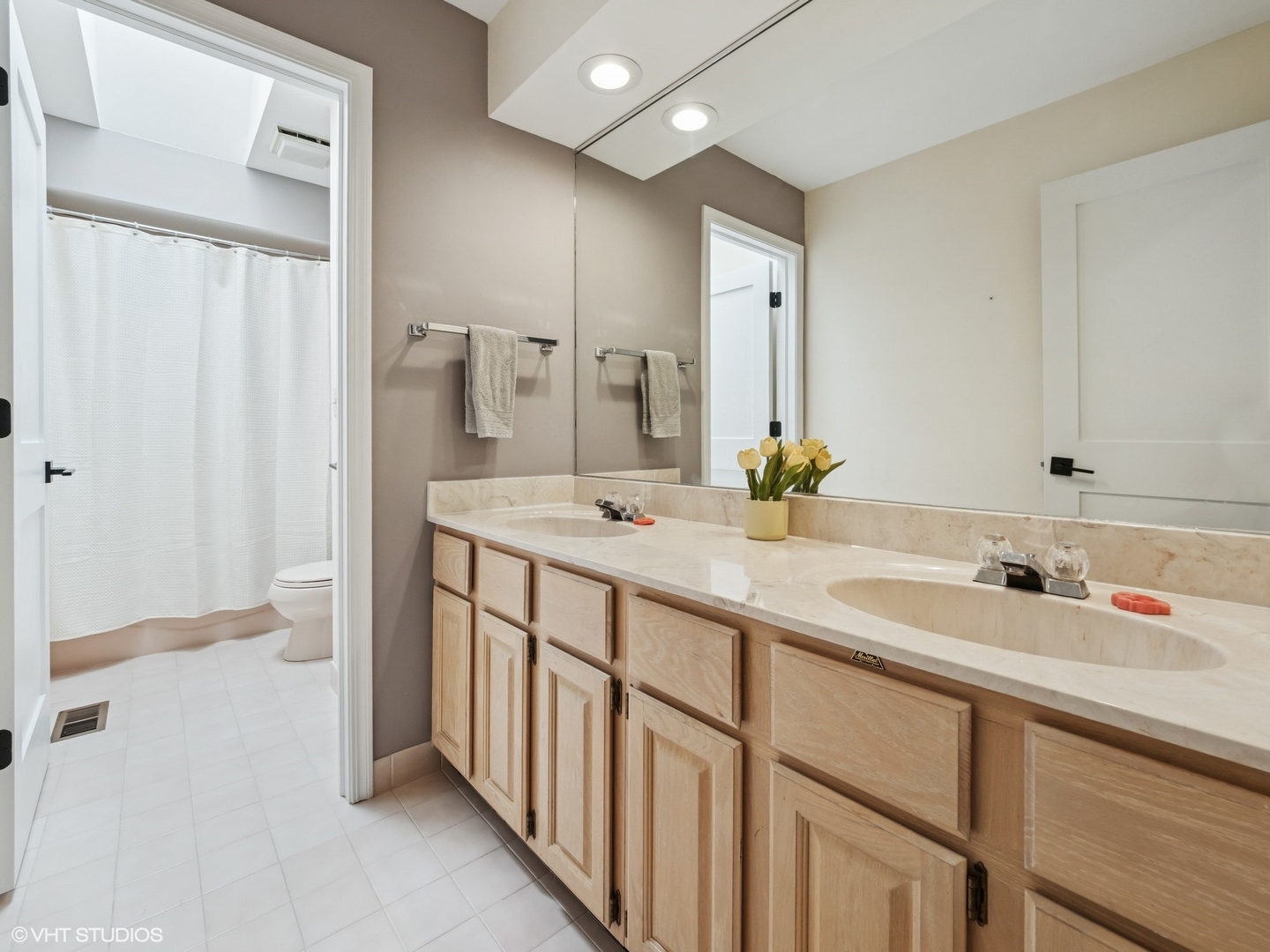1002 Elmdale Road Glenview, IL 60025 - Photo 37 of 51 a bathroom with a double vanity sink and a mirror