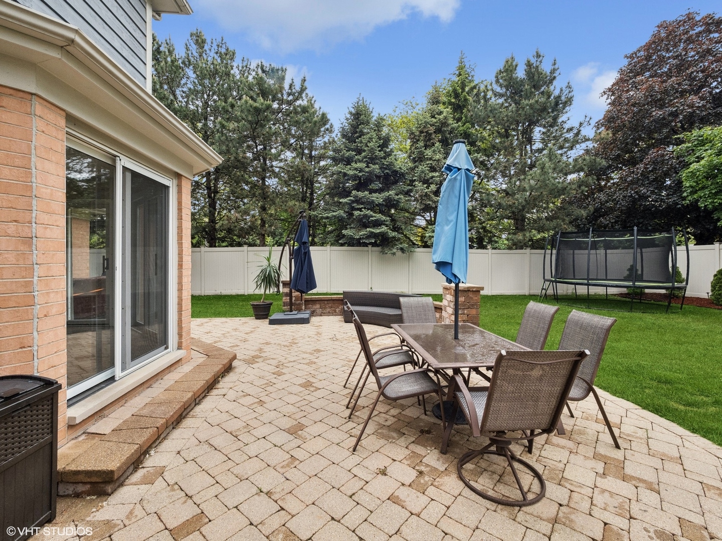 1002 Elmdale Road Glenview, IL 60025 - Photo 46 of 51 a view of a patio with a table chairs and a backyard