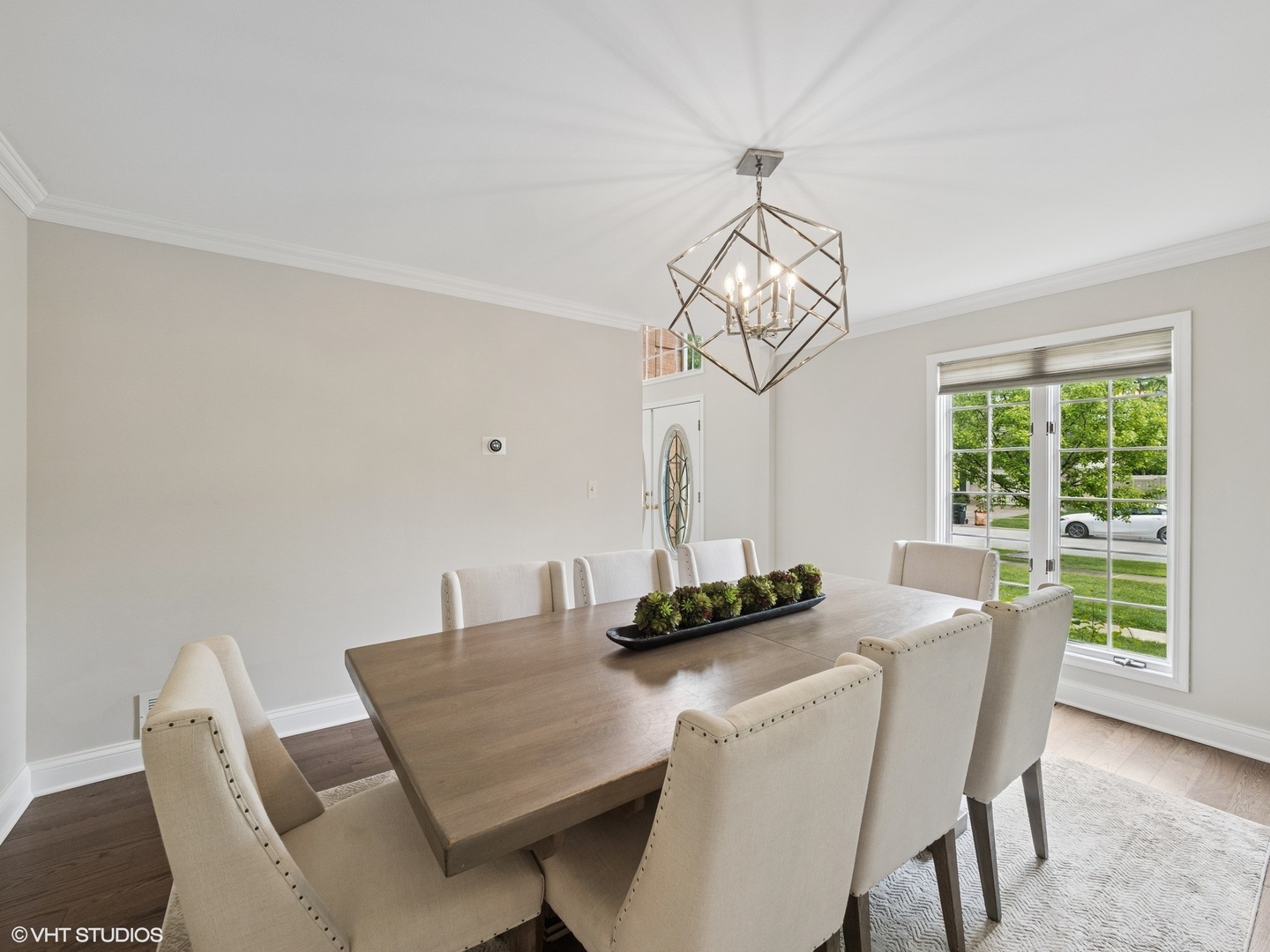 1002 Elmdale Road Glenview, IL 60025 - Photo 6 of 51 a dining room with furniture a rug and a chandelier