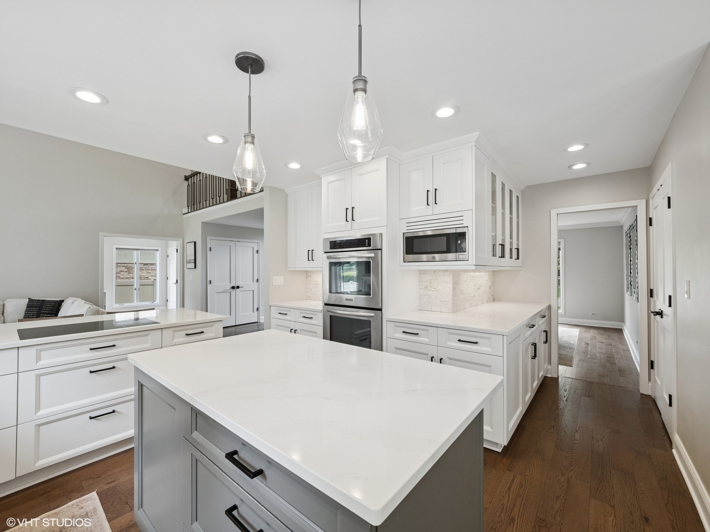 1002 Elmdale Road Glenview, IL 60025 - Photo 10 of 51 a large white kitchen with cabinets a sink a center island stainless steel appliances and a center island