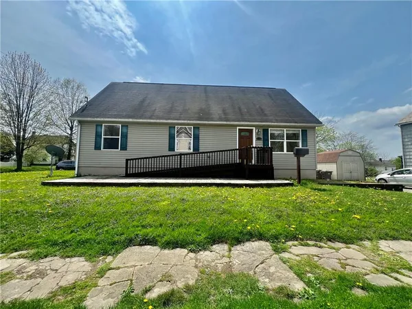 a front view of house with yard and green space