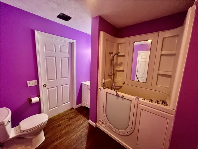 a bathroom with a toilet a sink and bath tub