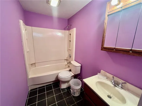 a bathroom with a sink toilet vanity and shower