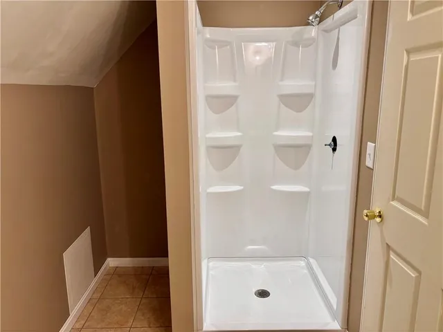 a bathroom with a glass shower door